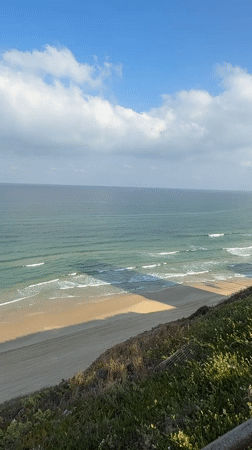 Surfers and paddleboarders out on the Netanya coast