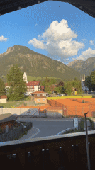 Tourist documents scenic Oberstdorf views from balcony overlook