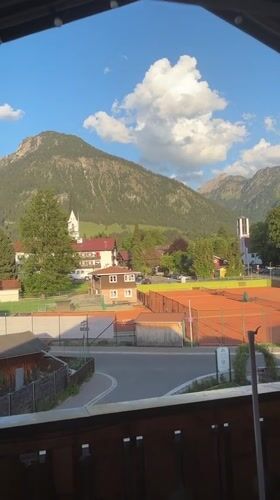 Tourist documents scenic Oberstdorf views from balcony overlook