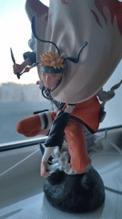 Naruto action figure displayed on window sill in dynamic pose