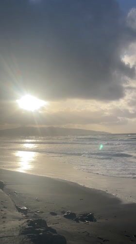 Dramatic sunset breaks through clouds over Ribeira Grande beach