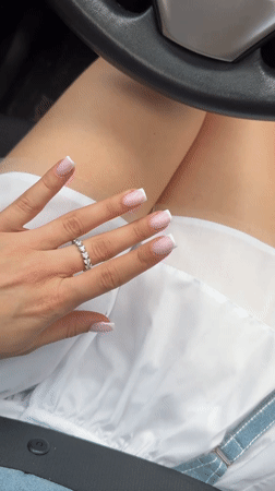 Woman takes selfie in car passenger seat in Kyiv