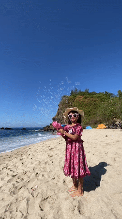 Families enjoy beach day with bubble play in Indonesia