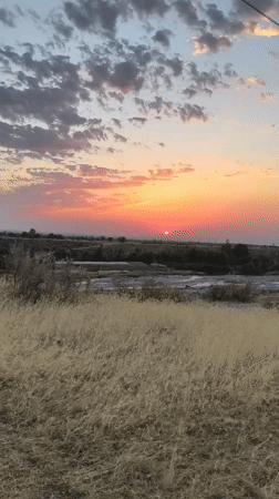 Golden sunset over Kyrgyzstan's open steppe and river plain