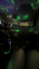 Car interior lit by disco lights in Rīga