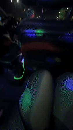 Car interior lit by disco lights in Rīga