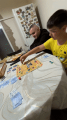 Family plays board game in Karlovo, Bulgaria