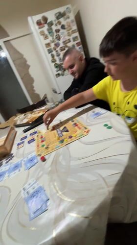 Family plays board game in Karlovo, Bulgaria