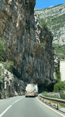 Tank truck travels highway near cliff face in Montenegro