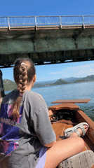 Girl in wooden boat spotted near railway bridge in Montenegro