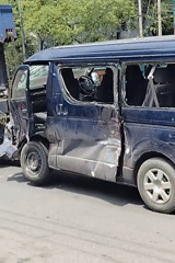 Damaged blue van towed through Dhaka streets