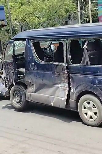 Damaged blue van towed through Dhaka streets