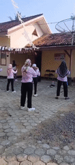 Group aerobics session in a Metro, Indonesia courtyard