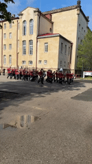 Military band parades in red uniforms through Sofia Bulgaria