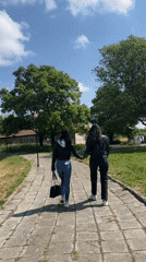 Two women walk together through Karnobat, Bulgaria streets
