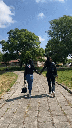 Two women walk together through Karnobat, Bulgaria streets