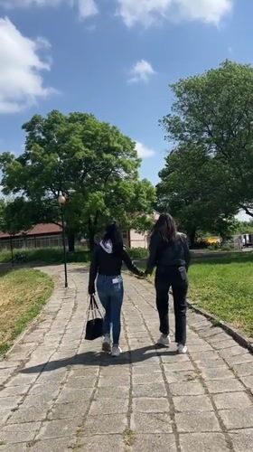 Two women walk together through Karnobat, Bulgaria streets