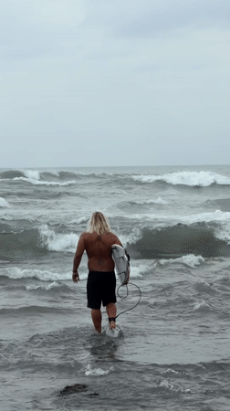 Morning beach activities observed in North Kuta under cloudy skies