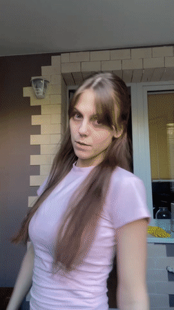 Woman in pink shirt photographed outside Ufa building