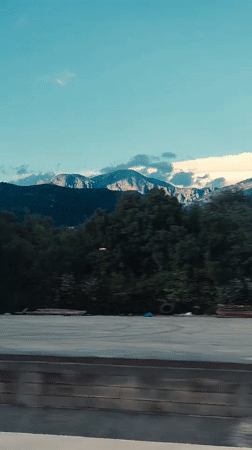 Driver travels through Montenegro mountain pass to urban area