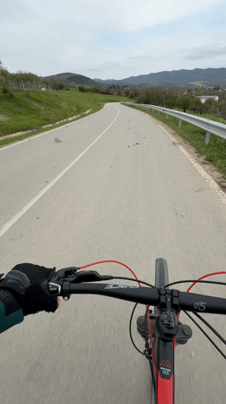 Cyclist rides divided road in Bulgarian village