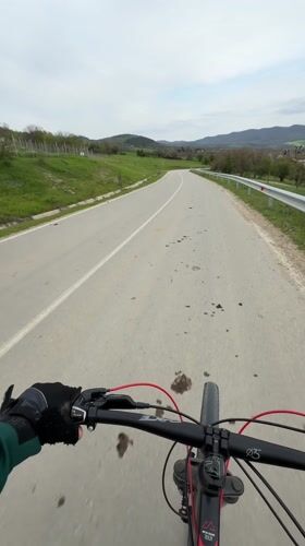 Cyclist rides divided road in Bulgarian village