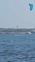 Kitesurfers ride clear water off a Denpasar beach
