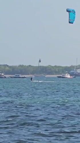 Kitesurfers ride clear water off a Denpasar beach
