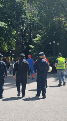Security escorts costumed individual in Yerevan gathering