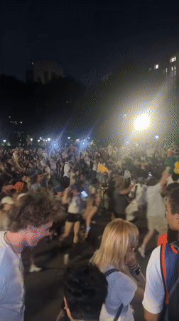 Late night crowd gathering and movement in New York