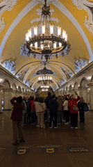 Tourist photography and commuter activity in decorated Moscow Metro stations