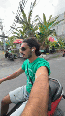 Man rides red scooter through North Kuta streets