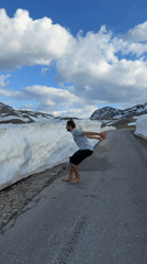 Man plays barefoot in roadside snow in Montenegro