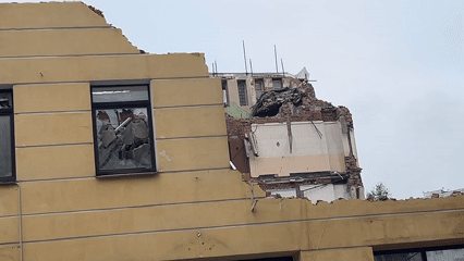 Building demolition draws onlookers as excavators work downtown