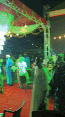 Nighttime cultural celebration with traditional performers captured by witnesses