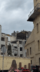 Building damaged in Kyiv, emergency responders on scene