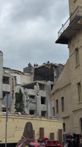 Building damaged in Kyiv, emergency responders on scene
