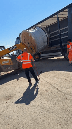 Construction crew unloads material spool in Smyadovo Bulgaria