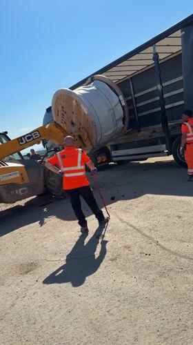 Construction crew unloads material spool in Smyadovo Bulgaria
