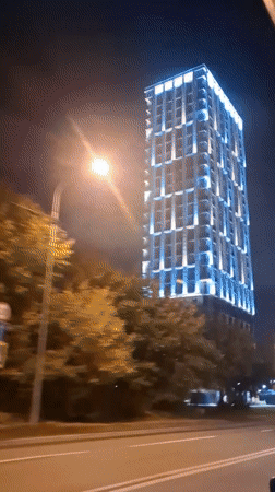 Tyumen residential park at night, modern towers meet Asian pavilion