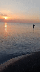 Sunset at Jangkar beach, fishing and a branded cup on the shore