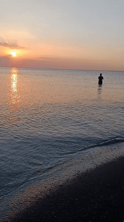 Sunset at Jangkar beach, fishing and a branded cup on the shore