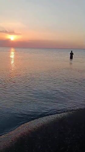 Sunset at Jangkar beach, fishing and a branded cup on the shore
