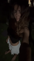 Woman films herself outdoors at night in North Kuta