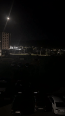 Full moon illuminates quiet residential area at night