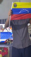 Man waves Venezuelan flag, captured in multiple moments in Juangriego