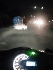 Cyclist pulls loaded cart through Lhokseumawe streets at night