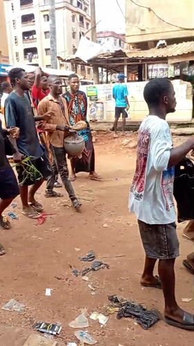 Unpaved streets documented in Onitsha, Nigeria during afternoon hours