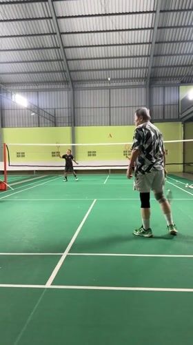 Indoor badminton match in full swing at Kuta Selatan court
