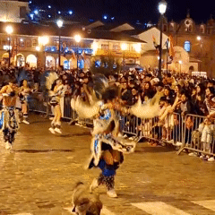 Traditional parade with costumed dancers in Cuzco's cobblestone streets